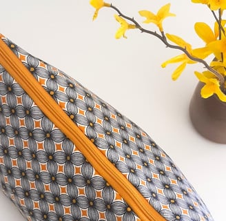 a small zippered pouchel bag with a yellow flower
