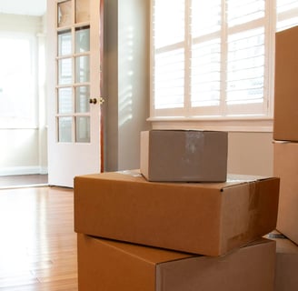an empty room with moving boxes