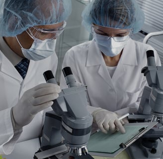 two people in lab coats and surgical masks