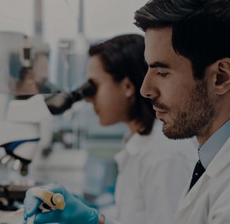 a man and woman in lab coats and gloves