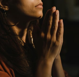 a woman in a red shirt is praying