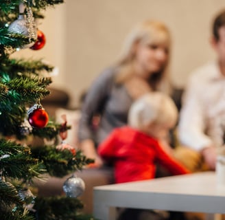 a family sitting on a couch in a living room