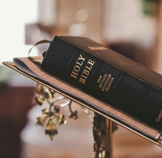 a bible with a bookmark on it and a cross on the side of a