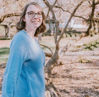 a woman, Kristin the VA, in glasses and a blue sweater