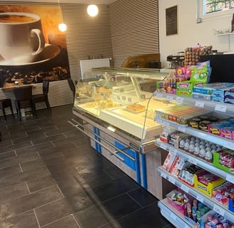 a coffee shop with a large cup of coffee and a cup of coffee
