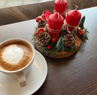 a cup of coffee with a candle on a table