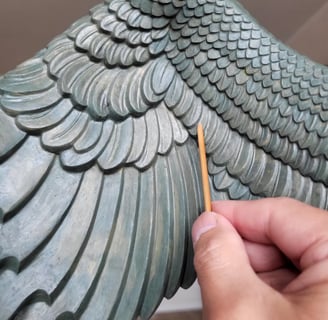 Creating the Garuda wings of clay.