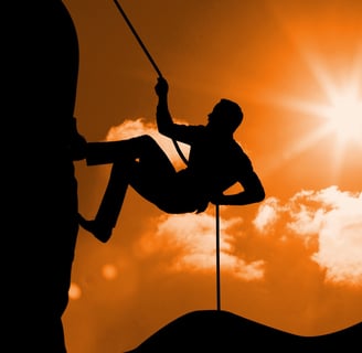 a man climbing a rock face on a rock