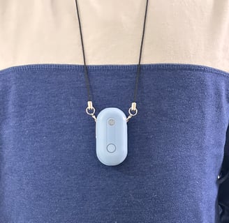 Person wearing Atovio air purifier