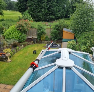 a roof top with a glass roof and a skylight