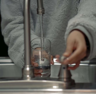 Woman turns on the kitchen sink
