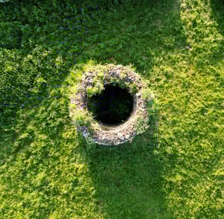 well opening in a grassy field