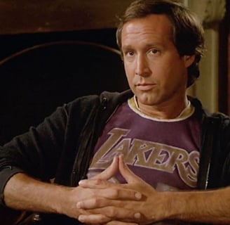 a man in a purple shirt and a black jacket