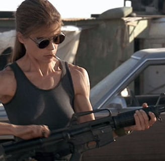 a woman in a tank top holding a gun