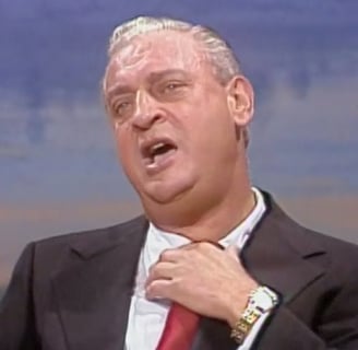 a man in a suit and tie with a red tie