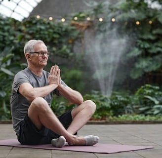 Elderly man meditating to clear his mind and rewire his mental health.