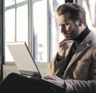 Man thinking while looking at his laptop. Why is there a connection between my mood and diet?