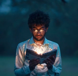 Man reading a book while a yellow glow is seen within it. Reading can help your mental health