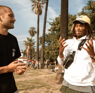 two men talking to each other at a park fostering a social connection for their mental health
