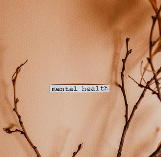 The word mental health written on the wall surrounded by branches