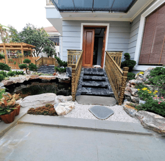 a house with a waterfall in the front yard