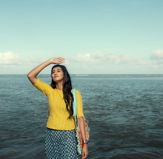 a woman in a yellow top and blue skirt
