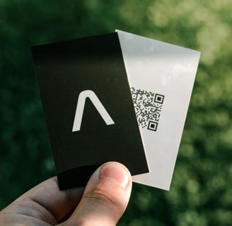 a person holding a piece of paper with a qr code on it