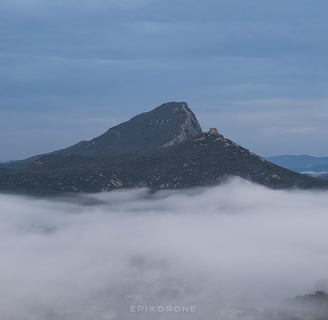 a mountain view of a mountain range with a few clouds