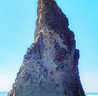 Oregon Coast - Sea stack rock on the waters edge is formed from lava at Bandon beach