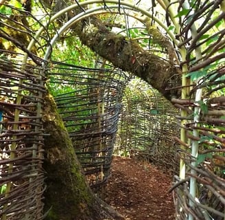 Eugene, OR - An arch tunnel made of wood on the trail at Mount Pisgah Arboretum