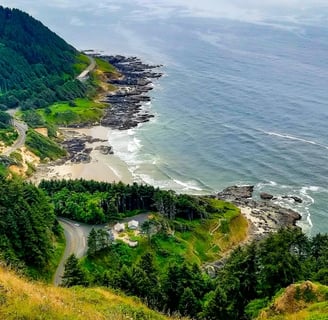 Oregon Coast - View from the mountain of Waldport and a beach surrounded by green forest