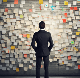 A man in a suit, facing a wall of to-do lists and overwhelmed by the burdens on his time