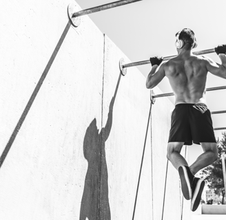 An image of a man doing pull-ups outside
