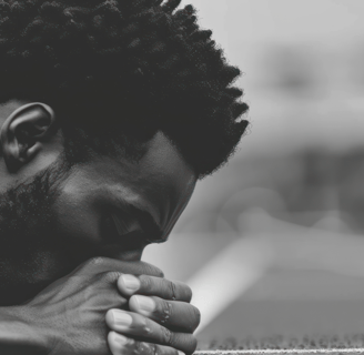Man head bowed suffering through pain