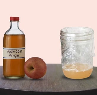 A homemade fruit fly trap using apple cider vinegar in a glass jar, designed to effectively catch fruit flies naturally