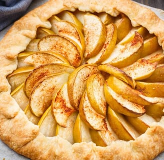 Freshly baked apple crostata featuring a flaky, golden crust, arranged with sliced Apples galette
