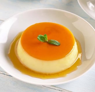 creamy caramel egg pudding topped with a glossy caramel layer, served on a white plate, showing its smooth and rich color 