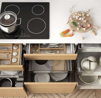 Neatly organized kitchen drawer with dividers for utensils, cutlery, and essential tools