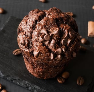 Olympics Chocolate Muffin Recipe topped with Chocolate chips and coffee beans along with Chocolate pieces 7 waffer