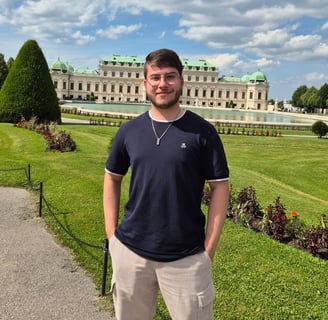 a man standing in front of a large building