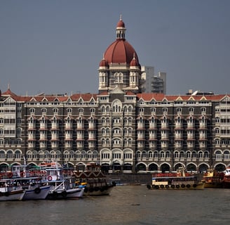 An image showing the Taj Mahal Palace hotel at its grand opening, capturing the building’s early architectural charm.