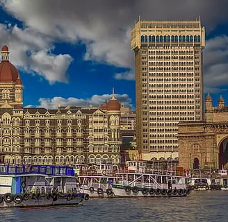  A modern image of the Taj Mahal Palace today, beautifully lit at night with the Gateway of India in
