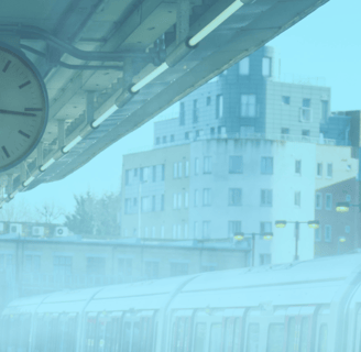 image of a clock on a train podium surrounded by fog