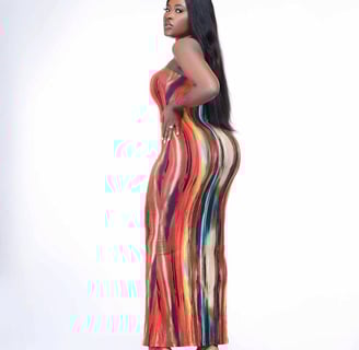 Fella Makafui in a multi-colored straight dress.