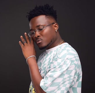 Highlife musician Bless in sunglasses and earrings.
