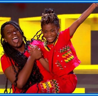 fronita and Abigail on the stage of Britain's Got Talent in an African wear.