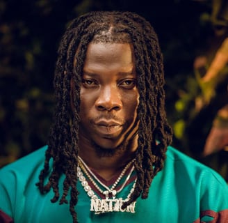 Stonebwoy in a green shirt.