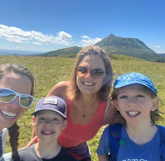 a family of three smiling and posing for a photo