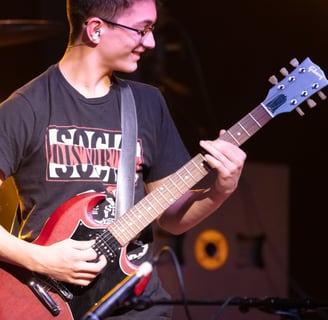 Gurnee Guitar Academy Guitar Lessons a man with a guitar and a guitar