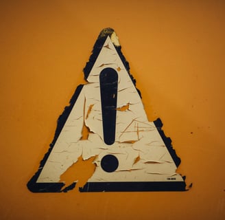 a sign that says caution on the side of a wall